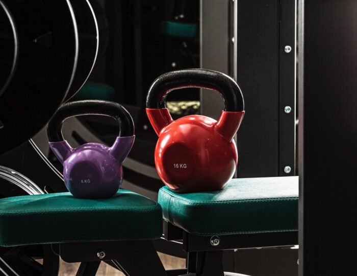 Sports equipment in gym. Dumbbells of different weight close up